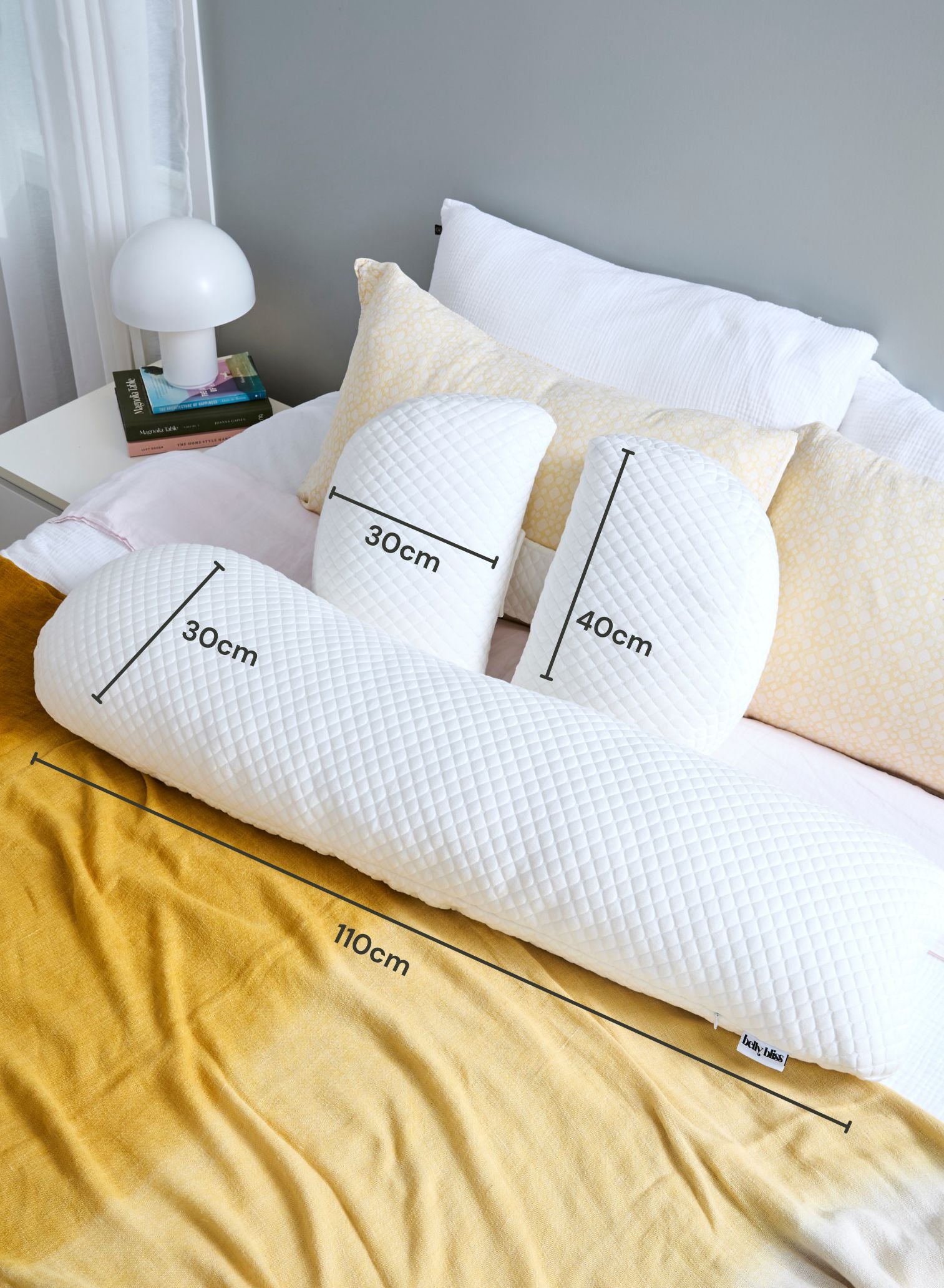 Belly Bliss pregnancy pillow in soft fabric, shaped to support pregnant belly and back during sleep.