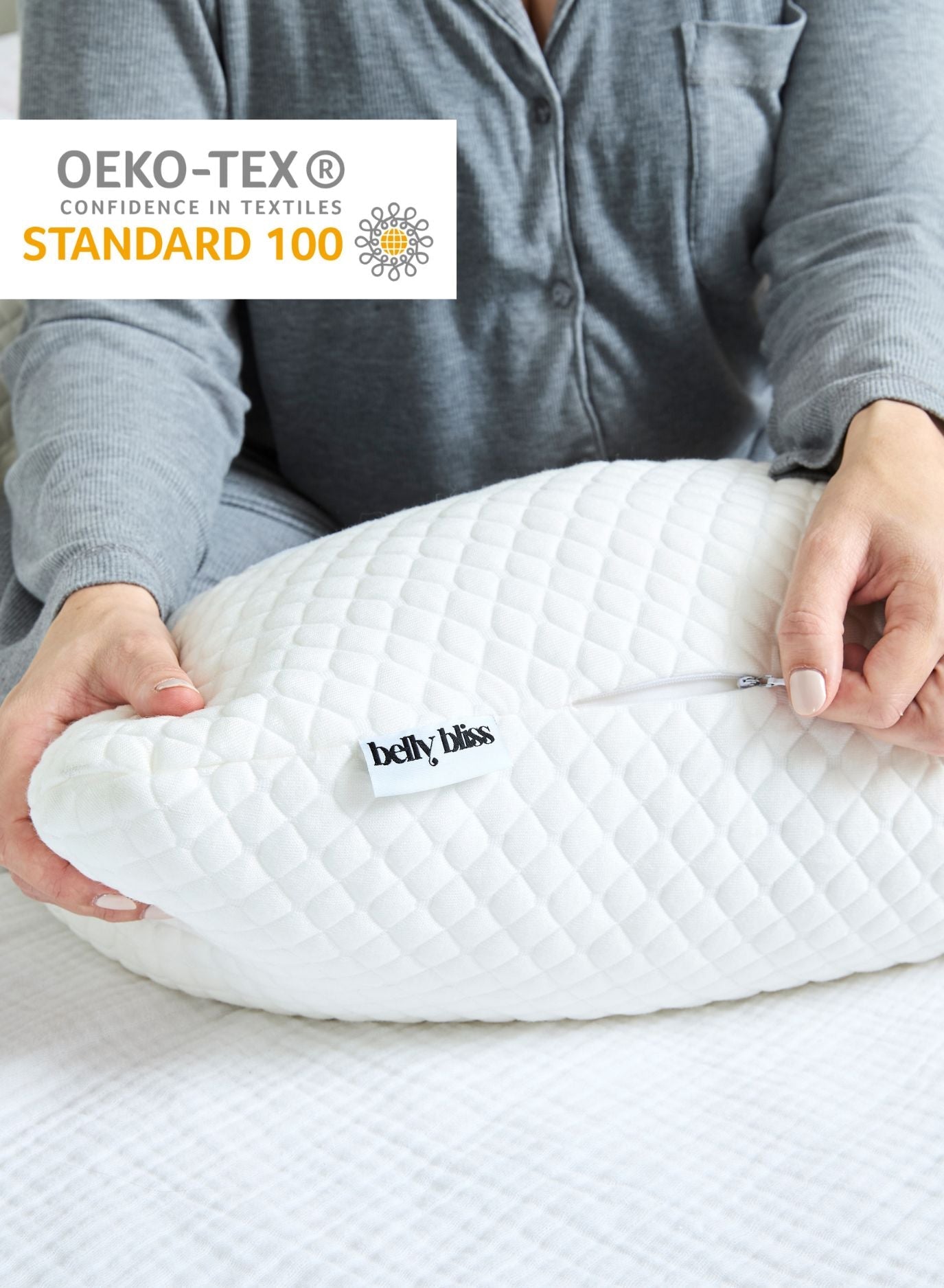 Belly Bliss pregnancy pillow in soft fabric, shaped to support pregnant belly and back during rest and sleep.