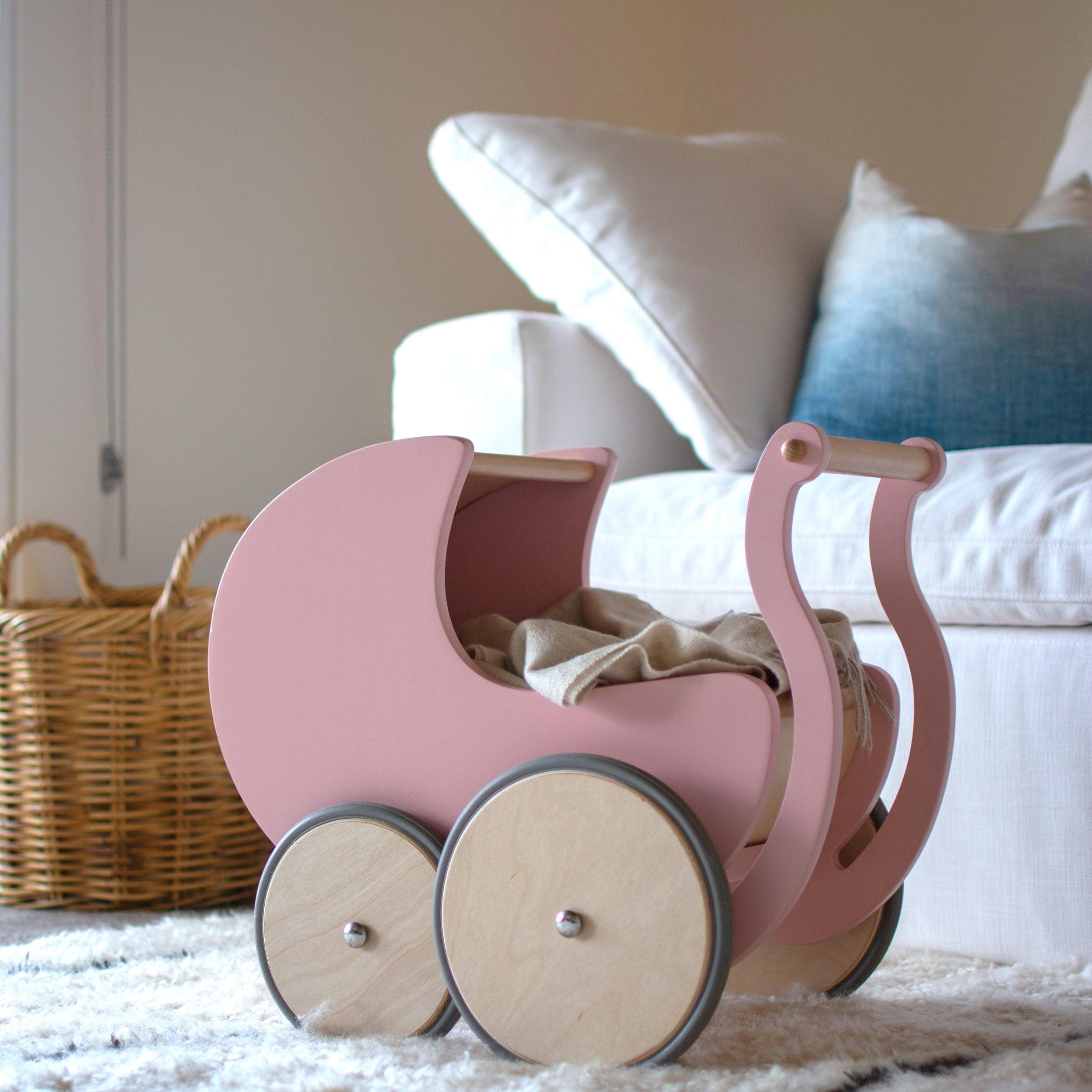 Wooden Kinderfeets Pram Walker in rose color, toddler toy with a sturdy wooden frame and colorful wheels for early walking support.