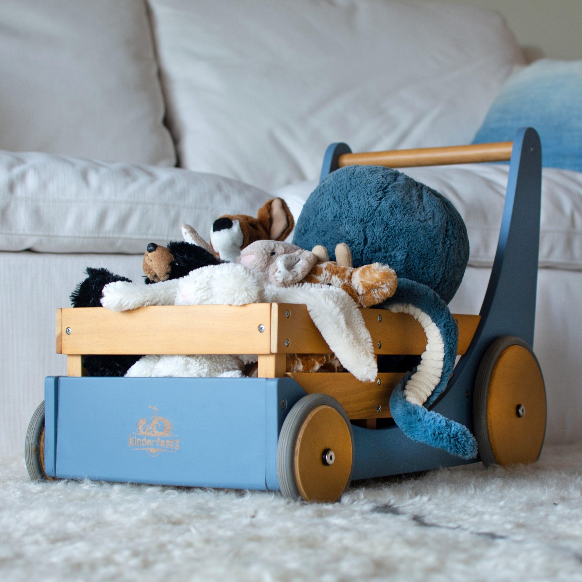 Kinderfeets Cargo Walker wooden toy in slate blue with natural wood accents, designed for early walkers and imaginative play.
