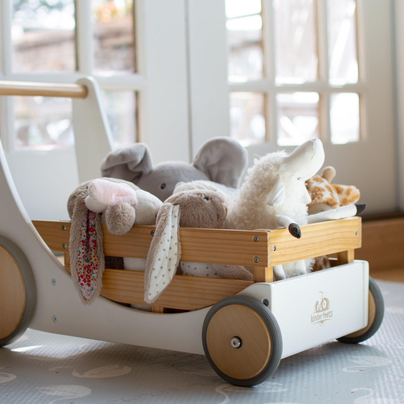 Kinderfeets Cargo Walker wooden toy in white, featuring a sturdy frame and colorful cargo compartments for toddler play.