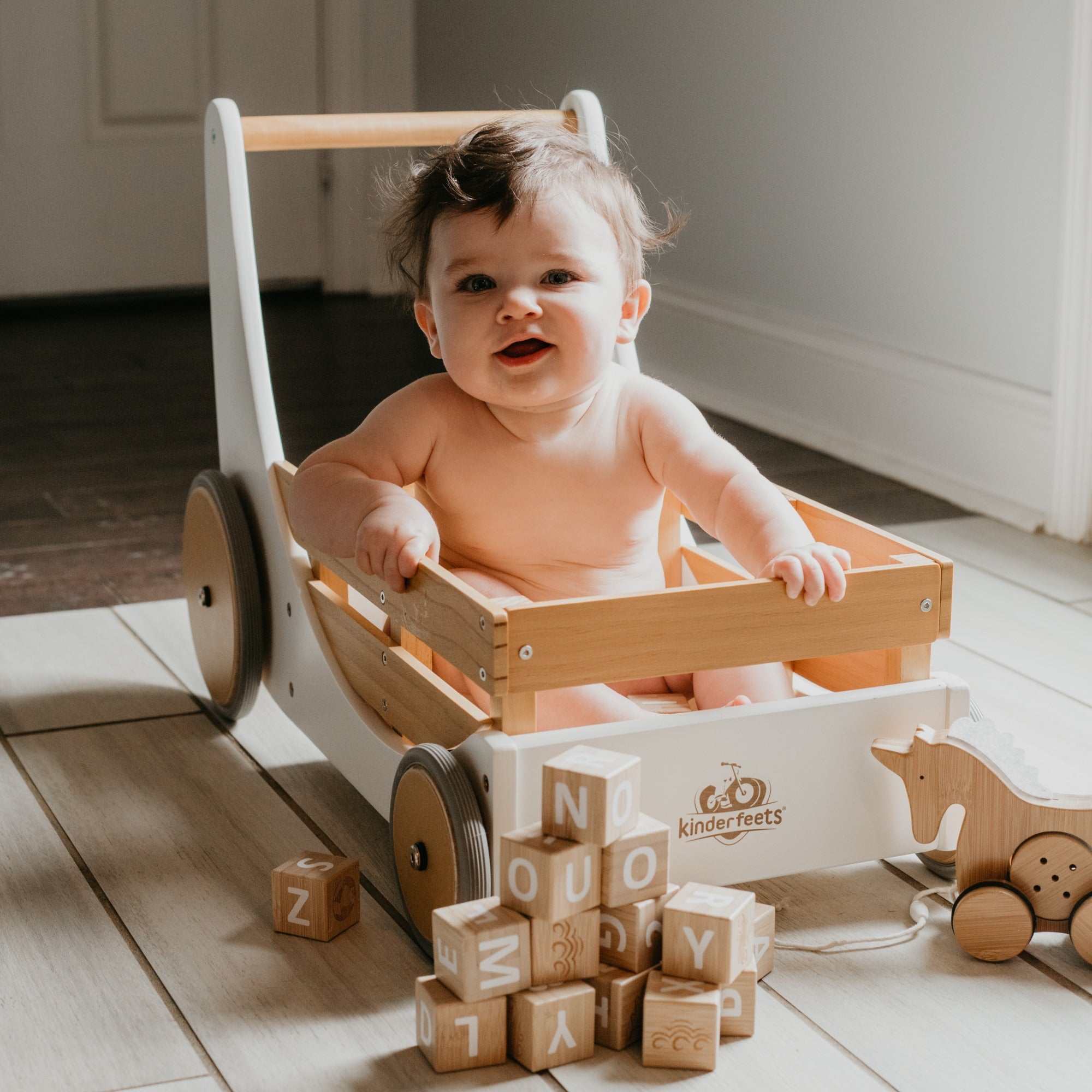 Kinderfeets Cargo Walker wooden toy in white, designed for toddlers to develop balance and coordination.