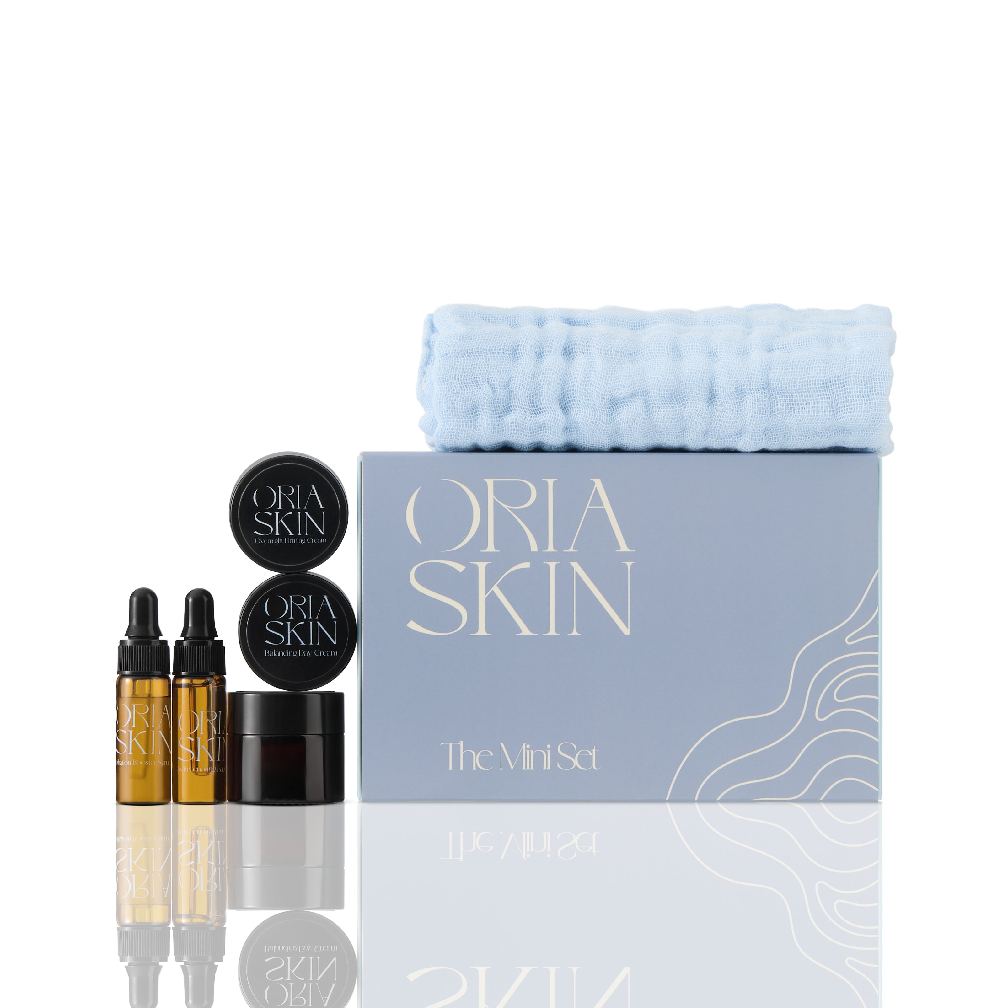 Oria Skin The Mini Set featuring skincare products in a compact, stylish package with various bottles and jars.