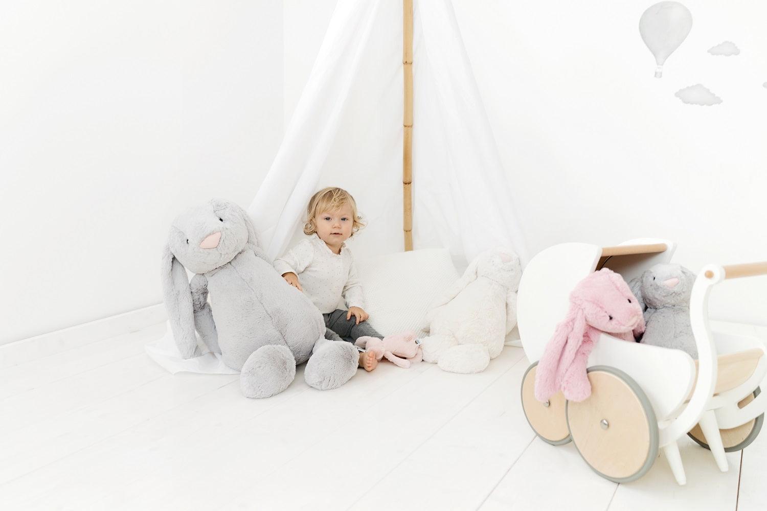 Wooden Kinderfeets Pram Walker in white for toddlers, featuring a classic design and sturdy wooden construction.