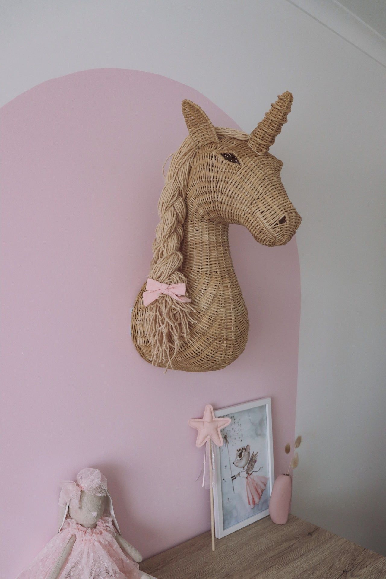 INKAH Limited Rattan unicorn wall mount decorative sculpture hanging on a wall, showcasing intricate woven rattan design and craftsmanship.