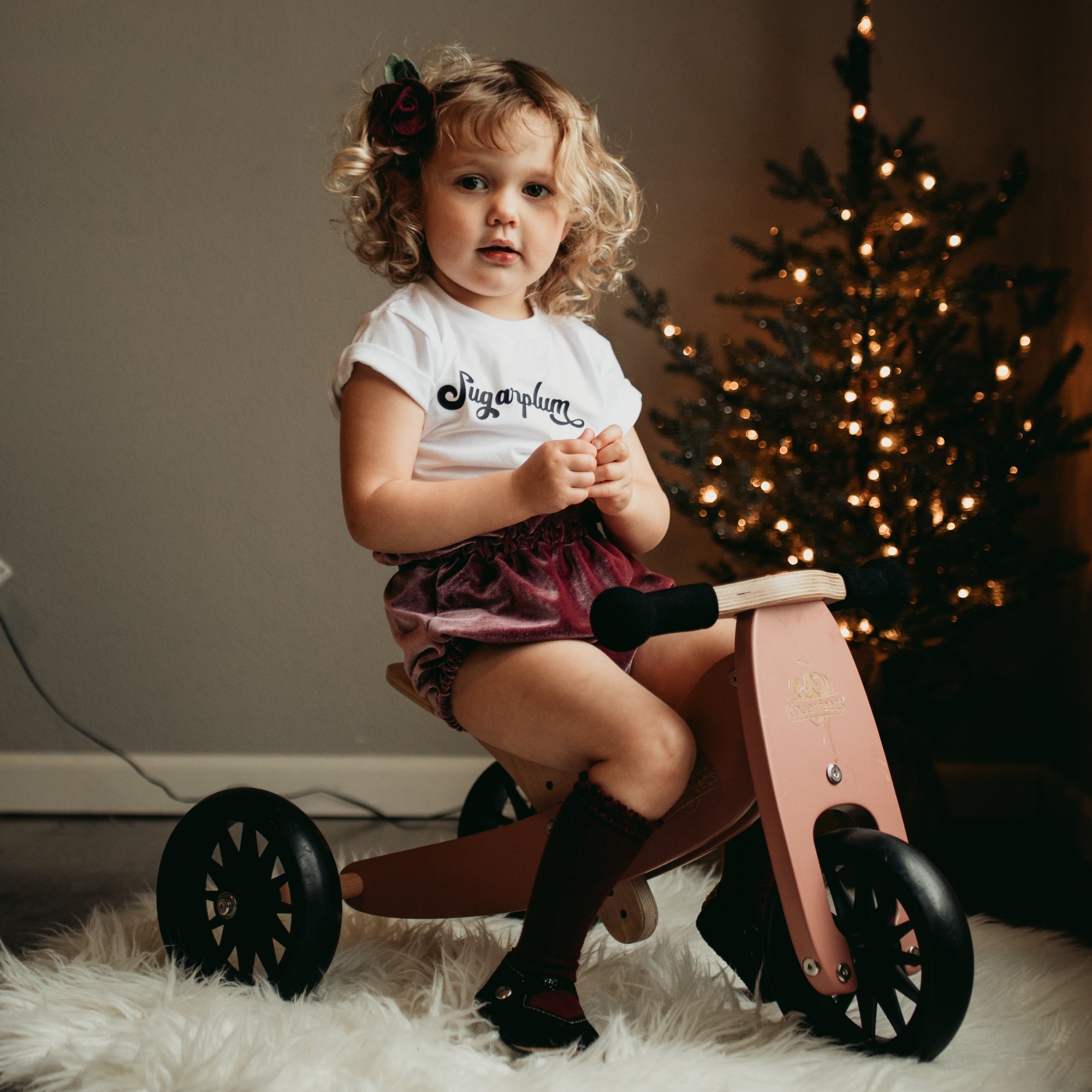 Kinderfeets Tiny Tot coral trike and balance bike for toddlers, featuring a sturdy wooden frame and colorful design.