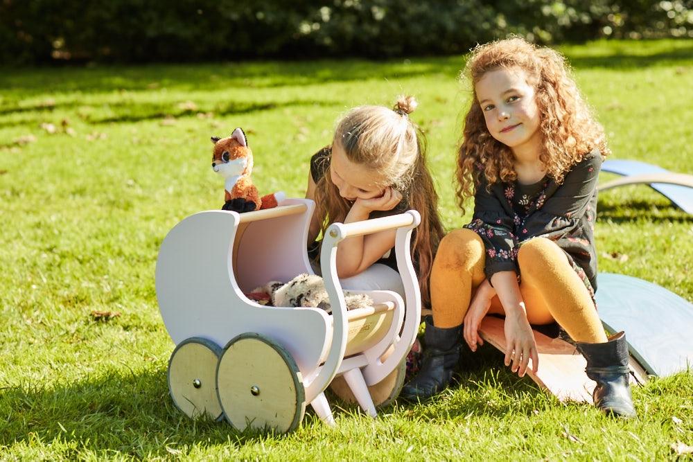 Wooden Kinderfeets Pram Walker in white, a classic toddler push toy with a sturdy wooden frame and playful design.