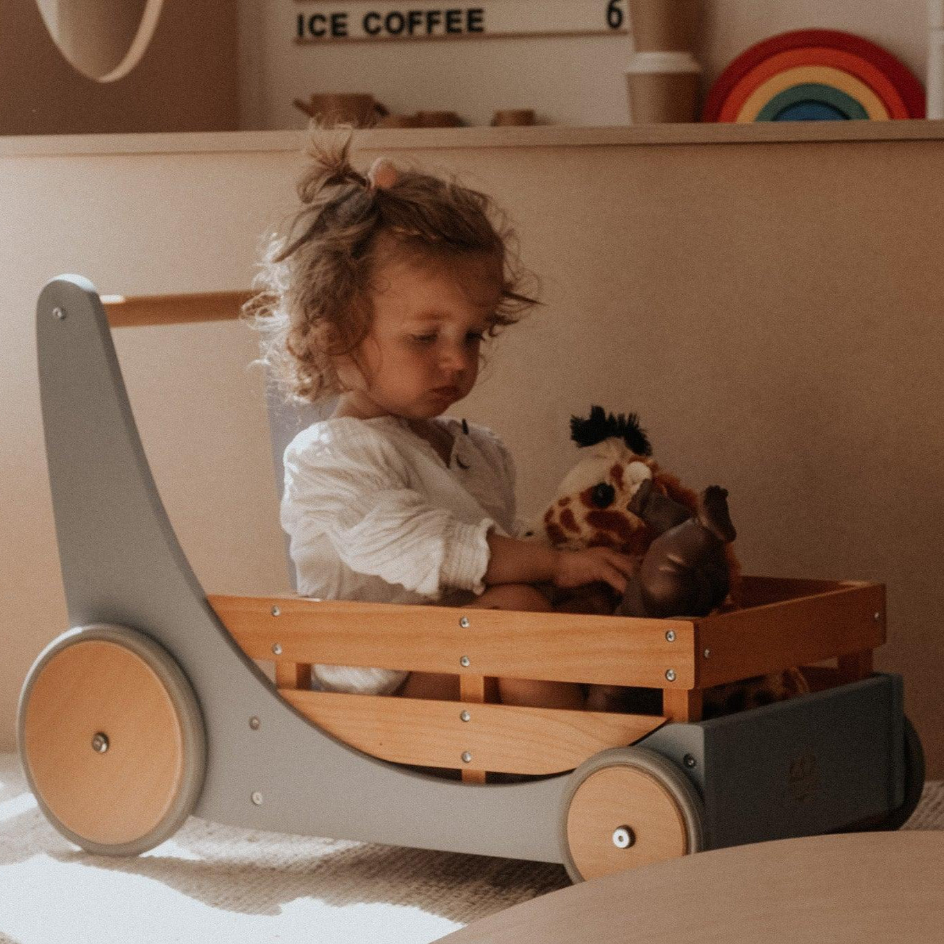 Kinderfeets Cargo Walker in slate blue, a wooden toy designed for early walkers, featuring a sturdy build and colorful details.
