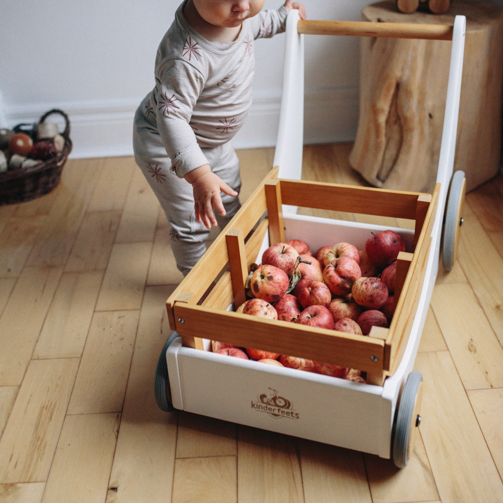 Kinderfeets Cargo Walker in white, a wooden toy designed for toddlers, featuring a classic, sturdy construction with a cargo storage area.