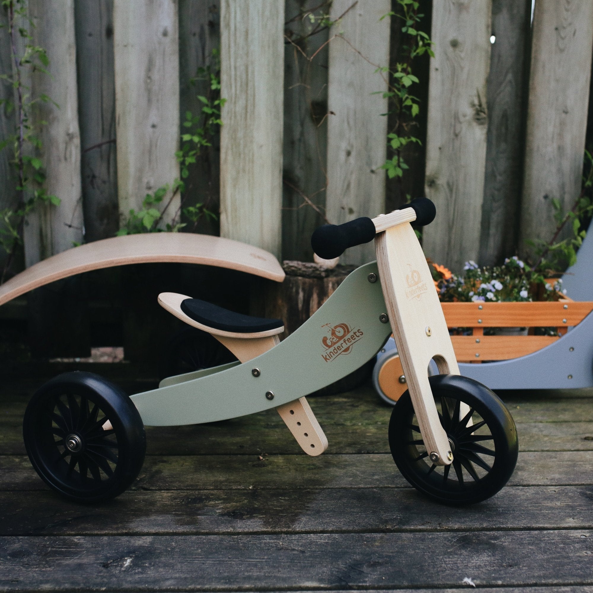 Kinderfeets Tiny Tots Plus balance bike in silver sage, featuring a lightweight frame, small wheels, and toddler-friendly design.