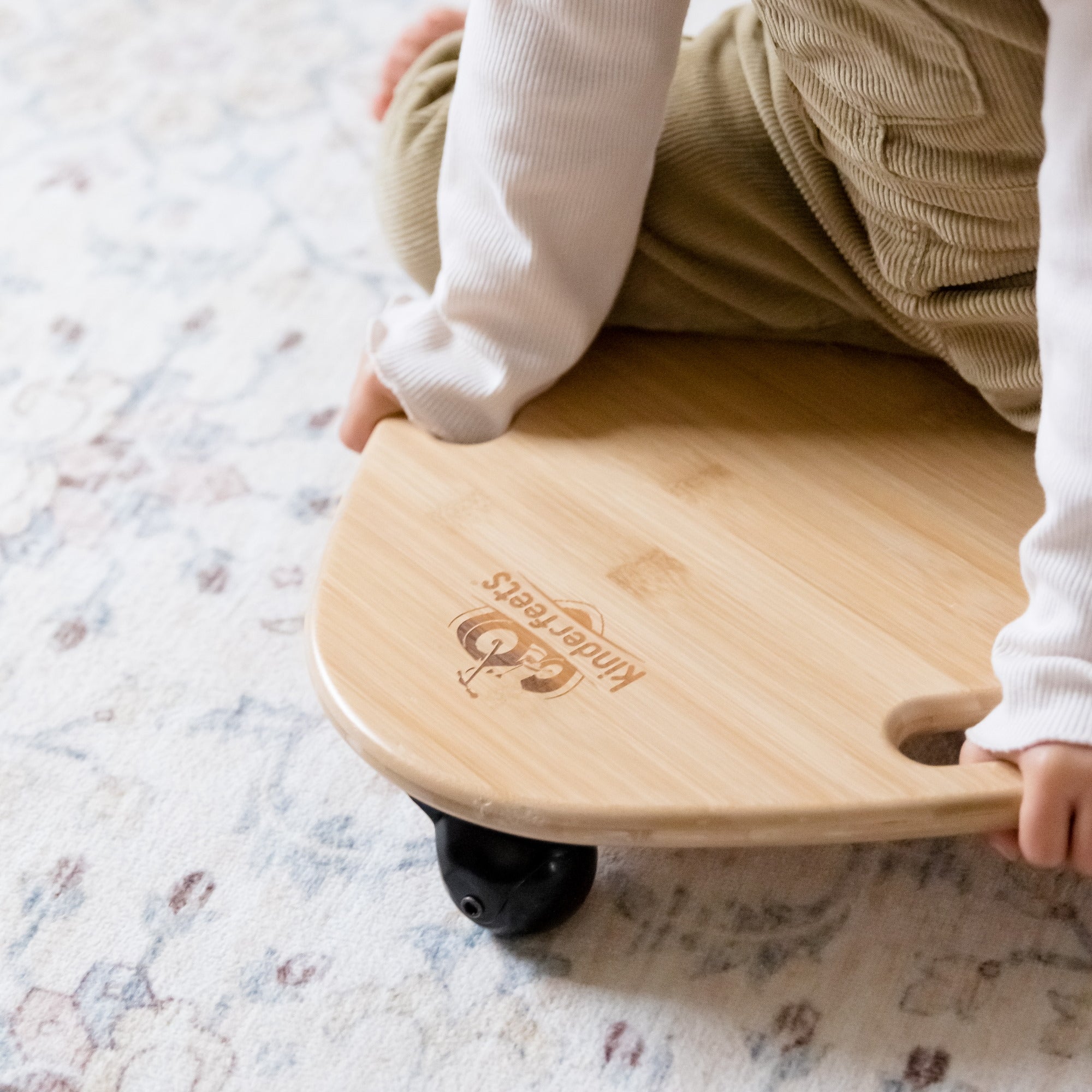 Kinderfeets Tummy Glider toy with colorful, smooth-rolling wheels and a sturdy wooden frame for young children to enjoy active play.