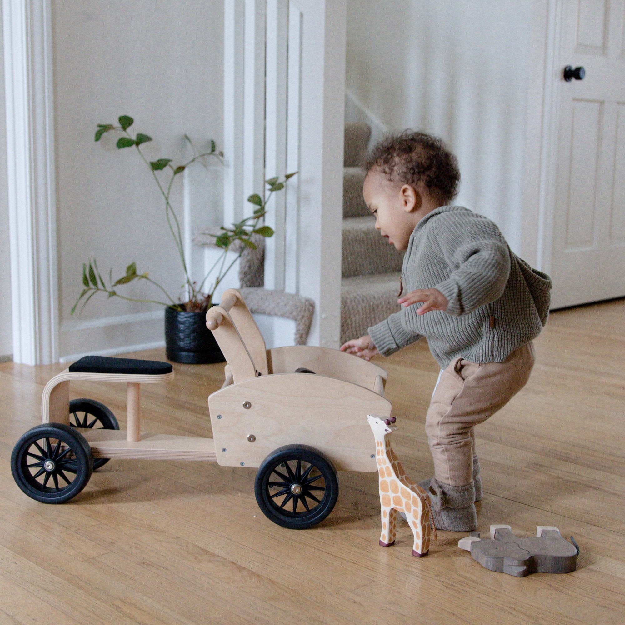 Kinderfeets Ride-on Cargo Cart toy for kids, featuring a wooden construction with colorful cargo storage area and sturdy wheels.