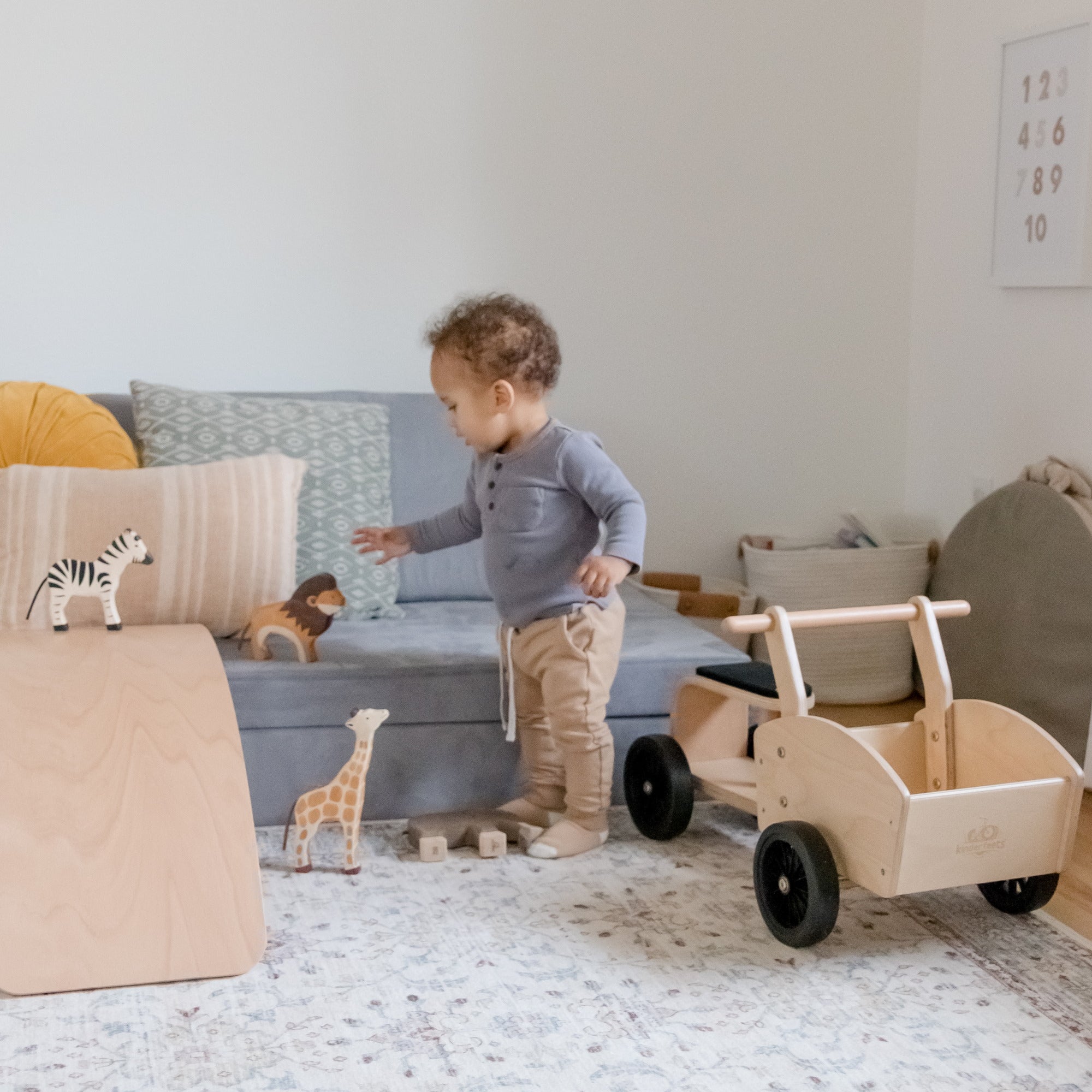 Kinderfeets Ride-on Cargo Cart toy for kids, featuring a wooden construction with colorful cargo storage and a sturdy handle.