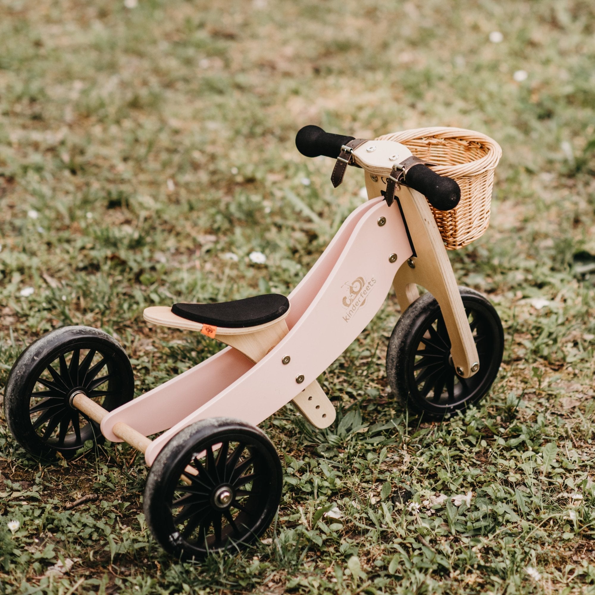 Kinderfeets Tiny Tot Plus rose balance bike for toddlers, featuring a lightweight frame and adjustable handlebars.
