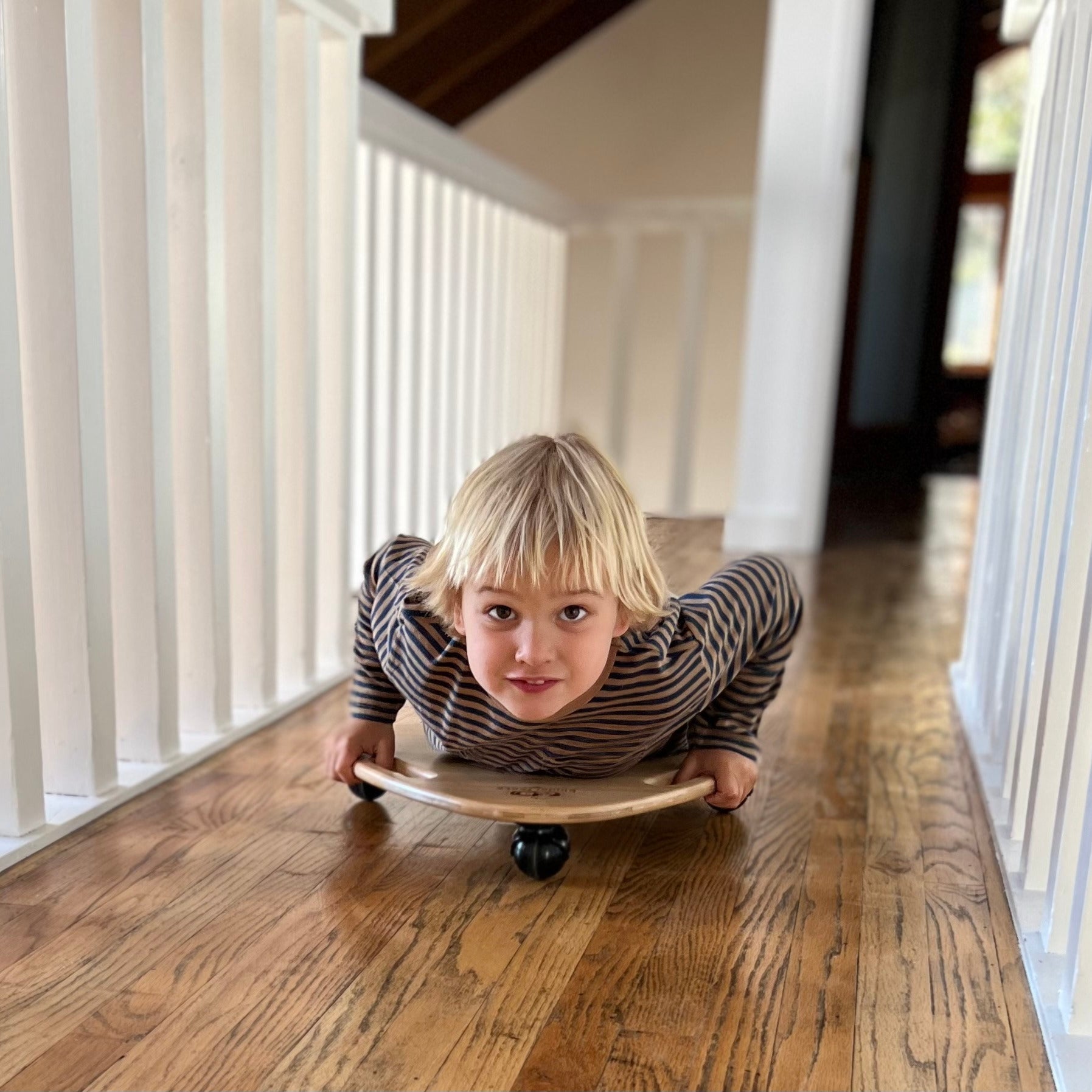 Kinderfeets Tummy Glider toy for children, featuring colorful plastic construction and smooth gliding design.
