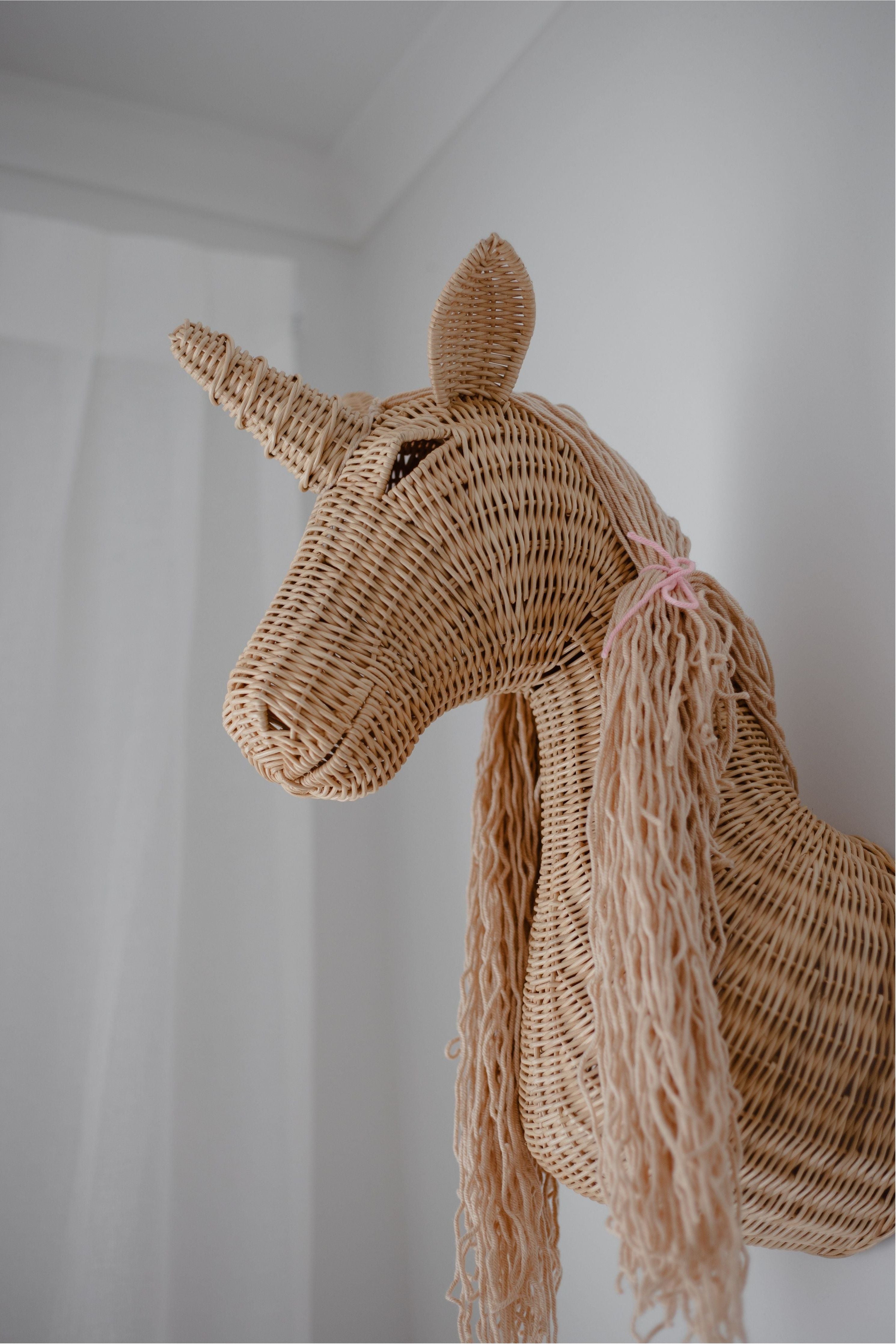 INKAH Limited rattan unicorn wall mount decor featuring a woven rattan unicorn with a natural finish and intricate detailing.