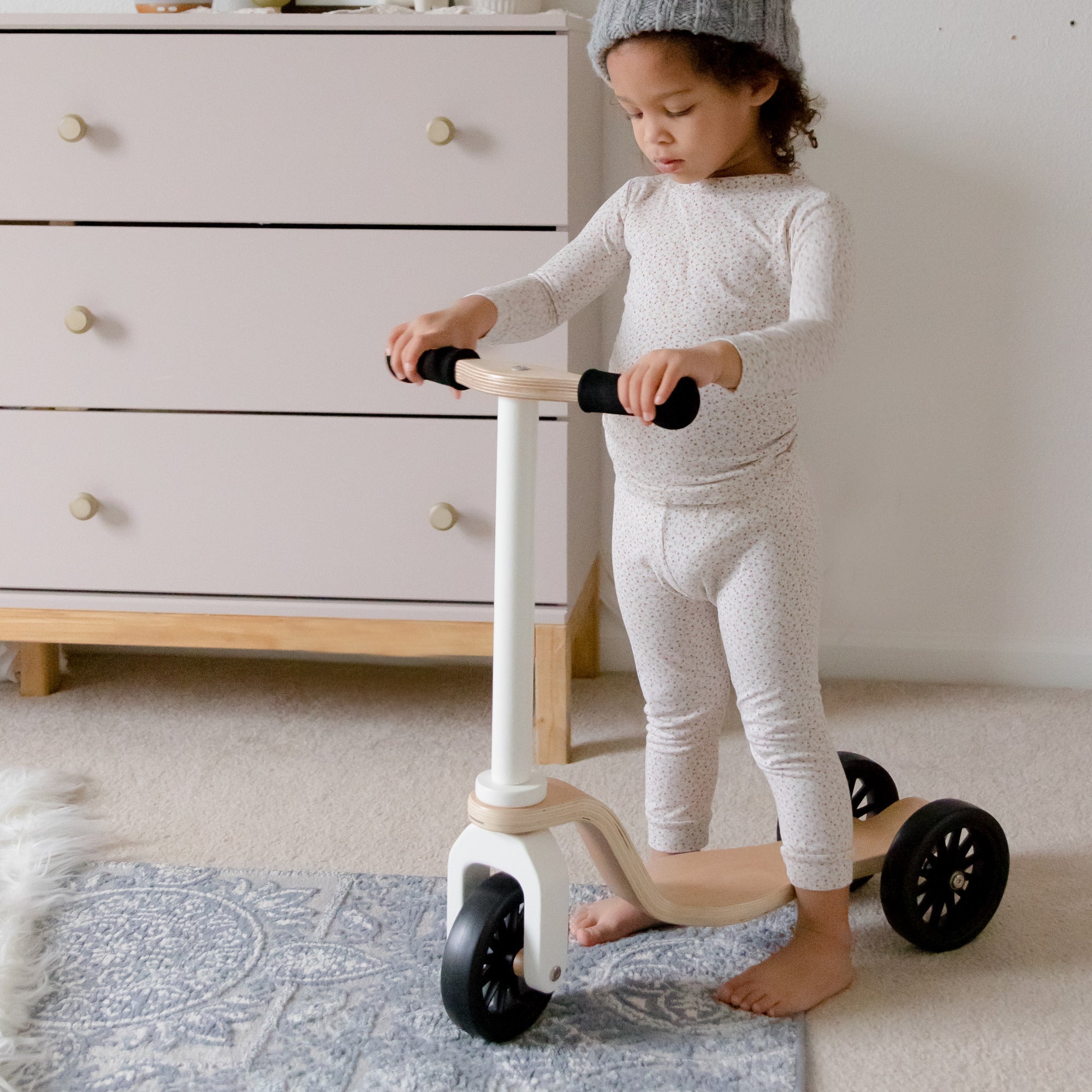 Kinderfeets scooter for kids with wooden deck and colorful handlebar, ideal for young children learning to ride.