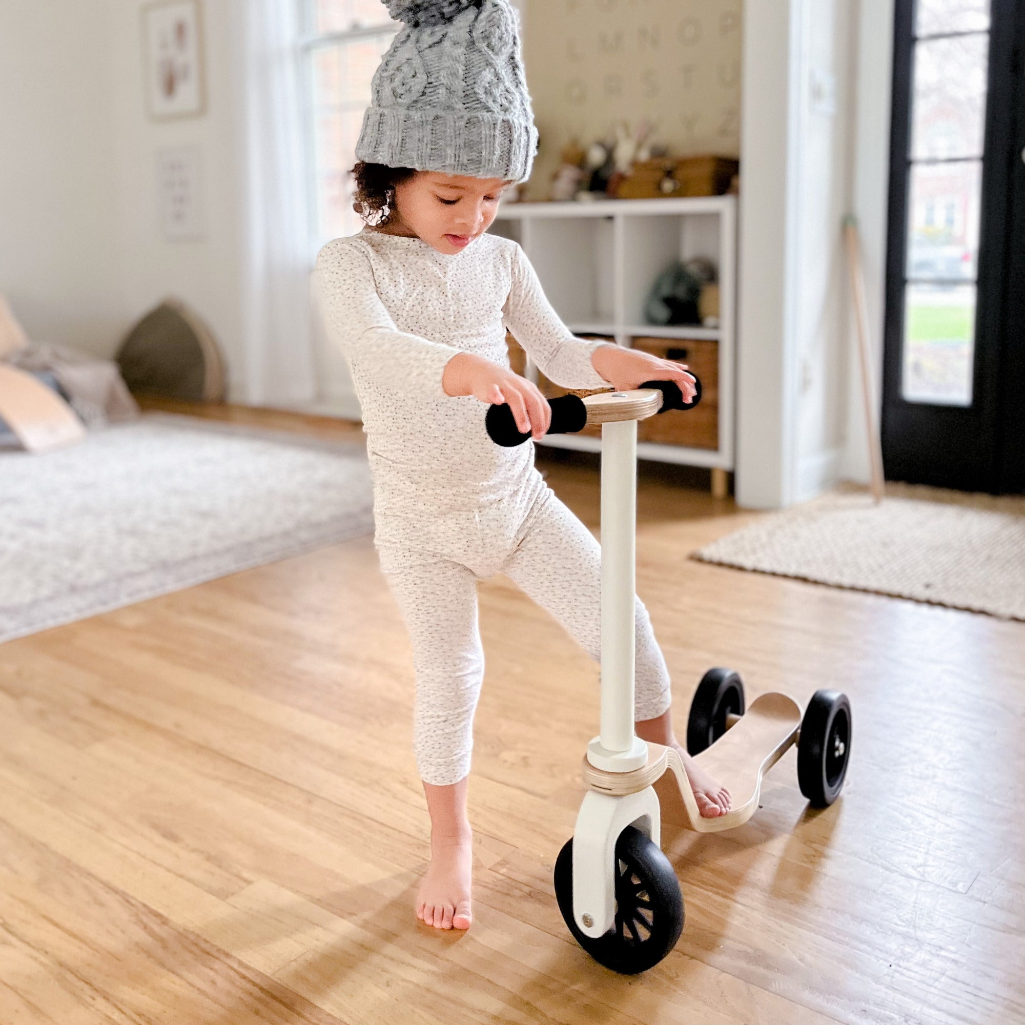 Kinderfeets scooter for kids with wooden deck and colorful handlebars, suitable for young children learning to ride.