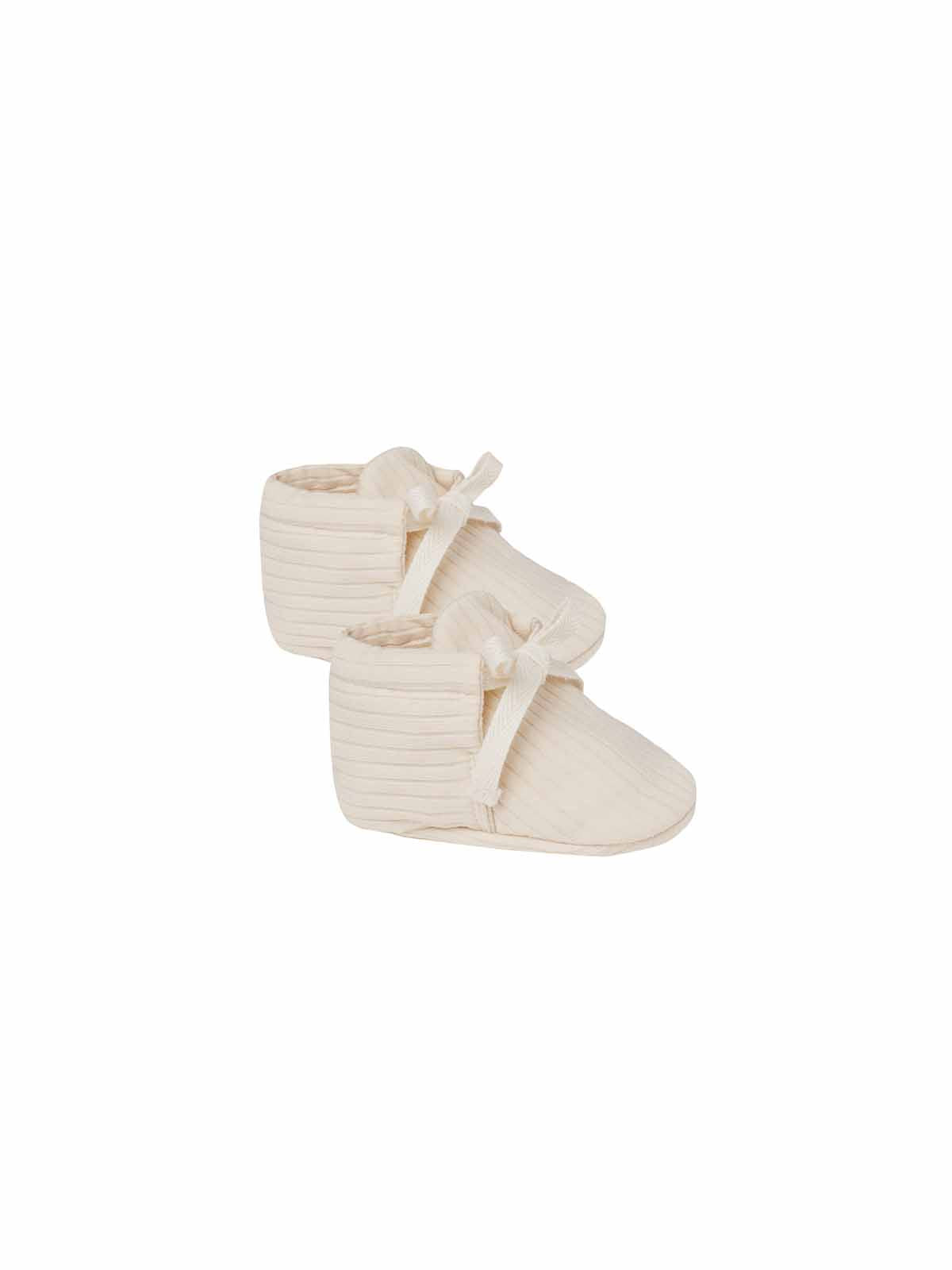 Ivory Quincy Mae baby booties made of soft fabric, featuring a cozy, snug fit for infants, in a natural and gentle style.