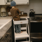 White Kinderfeets Pikler Observation Tower with rounded edges and wooden steps, designed for safe climbing and play.