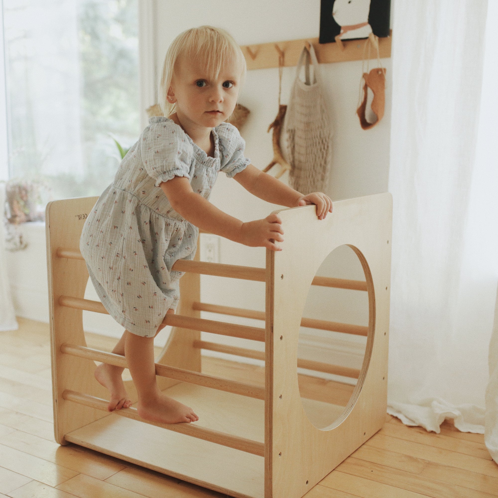 Kinderfeets Pikler Cube climbing toy with colorful wooden blocks for kids to explore and develop motor skills.