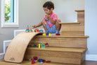 Kinderfeets Kinderboard in natural wood finish, featuring a compact, balanced wooden skateboard for kids' play and balance training.