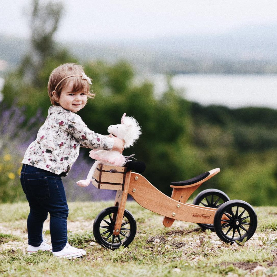 Kinderfeets Tiny Tot Mocha balance bike with a wooden frame and small handlebars, designed for young children learning to ride.