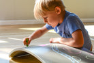 Kinderfeets Kinderboard balance board with chalkboard surface, designed for kids to balance and draw on.