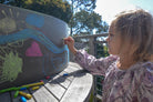 Kinderfeets Kinderboard chalkboard balance board with a wooden surface and chalk, designed for kids' active play and balance development.