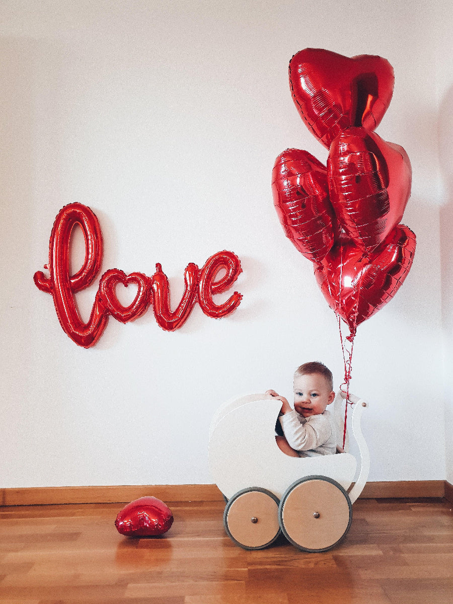 Wooden Kinderfeets Pram Walker in white, designed for toddlers, featuring a classic wooden frame and playful, supportive design.