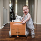 Kinderfeets wooden toy box and walker in white and bamboo, featuring a sturdy design with smooth finish and natural wood accents.