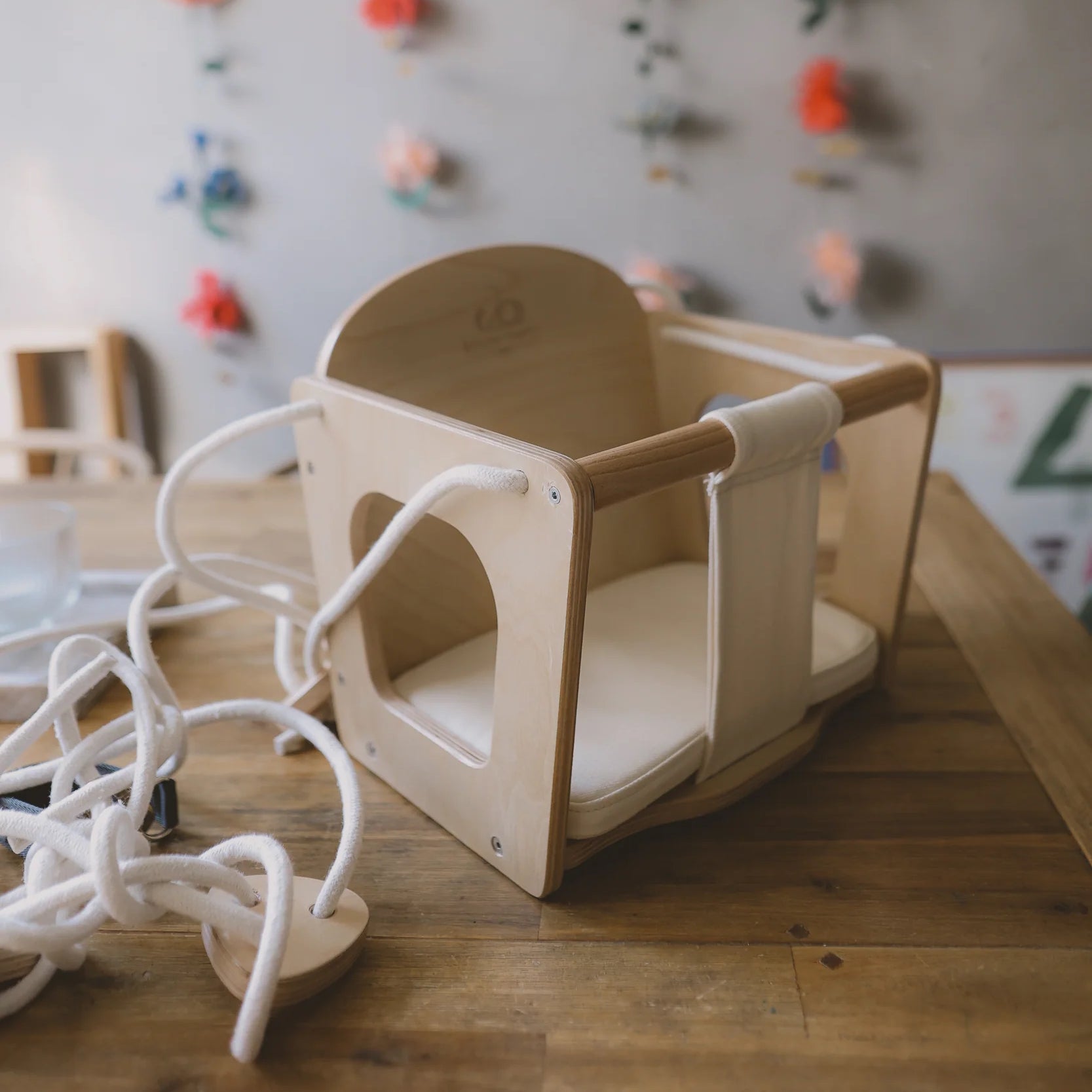 Kinderfeets Baby Swing hanging from a sturdy frame, featuring a comfortable seat and safety harness for gentle rocking.