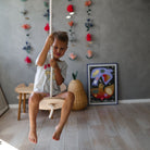 Kinderfeets Swinging Disc toy with colorful design, featuring a wooden handle and vibrant fabric for indoor play.