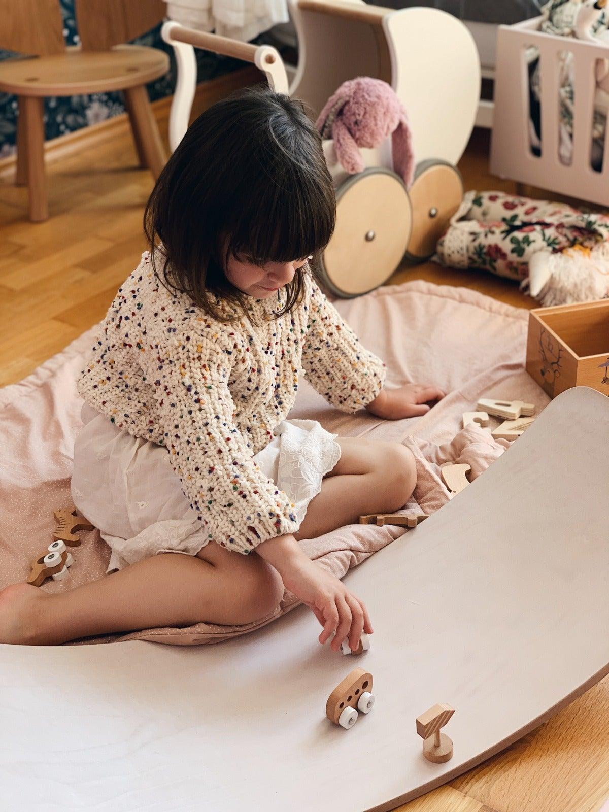 Kinderfeets Kinderboard in white wash finish, showcasing a small wooden balance board for kids with natural wood grain details.