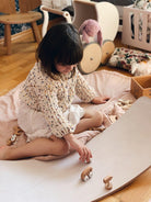 Kinderfeets Kinderboard in white wash finish, showcasing a small wooden balance board for kids with natural wood grain details.