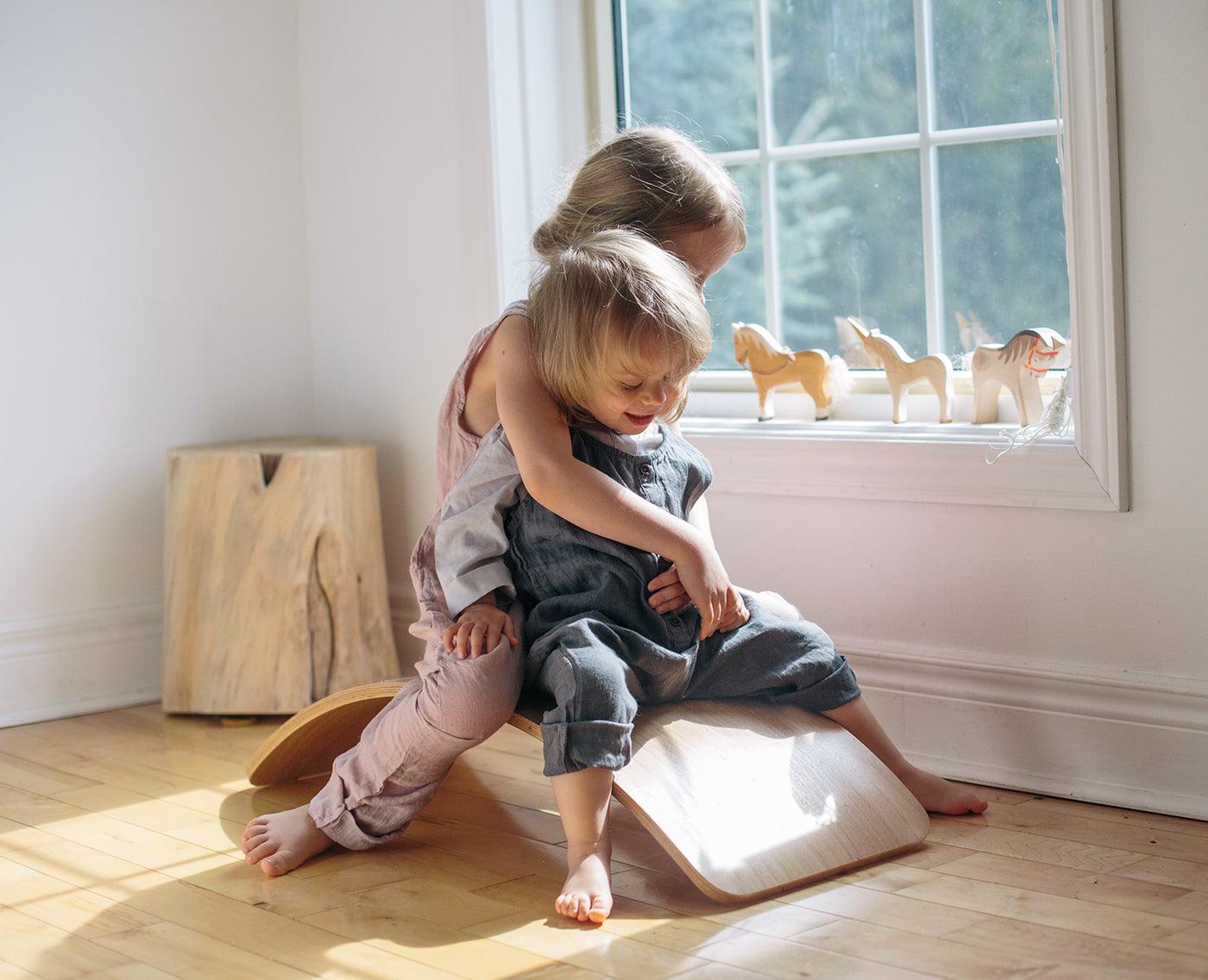 Kinderfeets Kinderboard in natural wood finish, featuring a compact, stable balance board for kids with a smooth, polished surface.