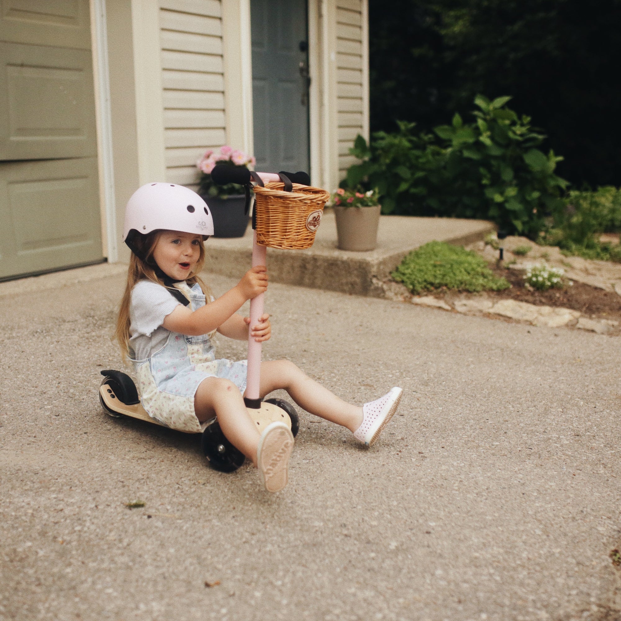 Kinderfeets Kinder Scooter in pink with a sturdy wooden frame and adjustable handlebars for young children.
