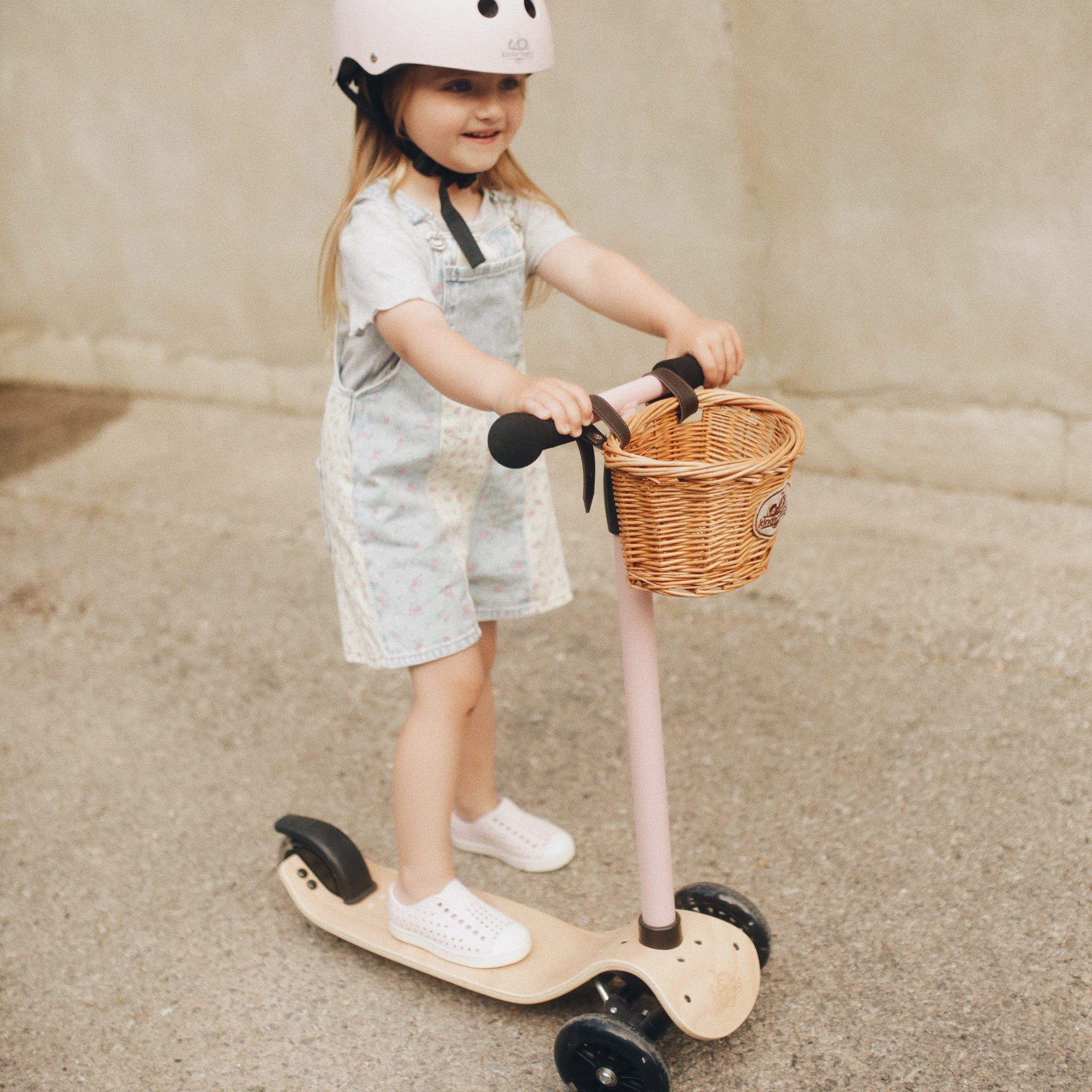 Kinderfeets Kinder Scooter in rose color, lightweight kids' scooter with adjustable handlebars and sturdy design for young children.