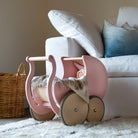 Wooden Kinderfeets Pram Walker in rose color, designed for toddlers, featuring a classic wooden frame and playful design.