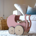 Wooden Kinderfeets Pram Walker in rose color, toddler toy with a sturdy wooden frame and colorful wheels for early walking support.