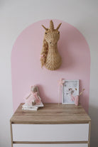 Rattan unicorn wall mount by Inkah Limited, featuring a woven natural rattan unicorn design on a white wall.