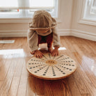 Kinderfeets Bamboo Balance Disc for kids, round balance disk with natural bamboo finish for stability and fun exercise.