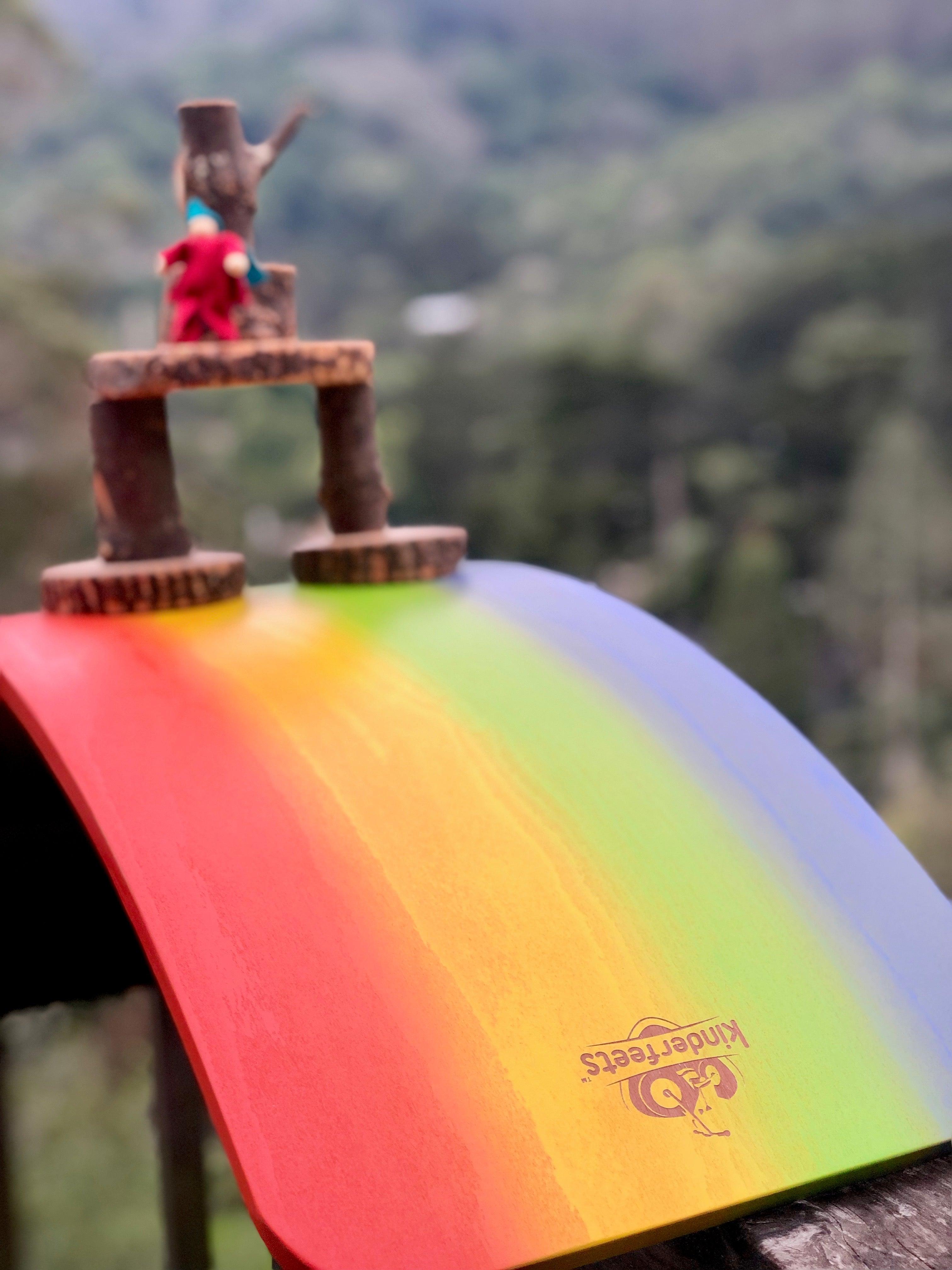 Kinderfeets Kinderboard Rainbow balance board with colorful rainbow design for kids to improve balance and coordination.