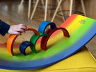 Kinderfeets Rainbow Kinderboard balance board with colorful rainbow design and wooden construction for kids' balance and coordination.