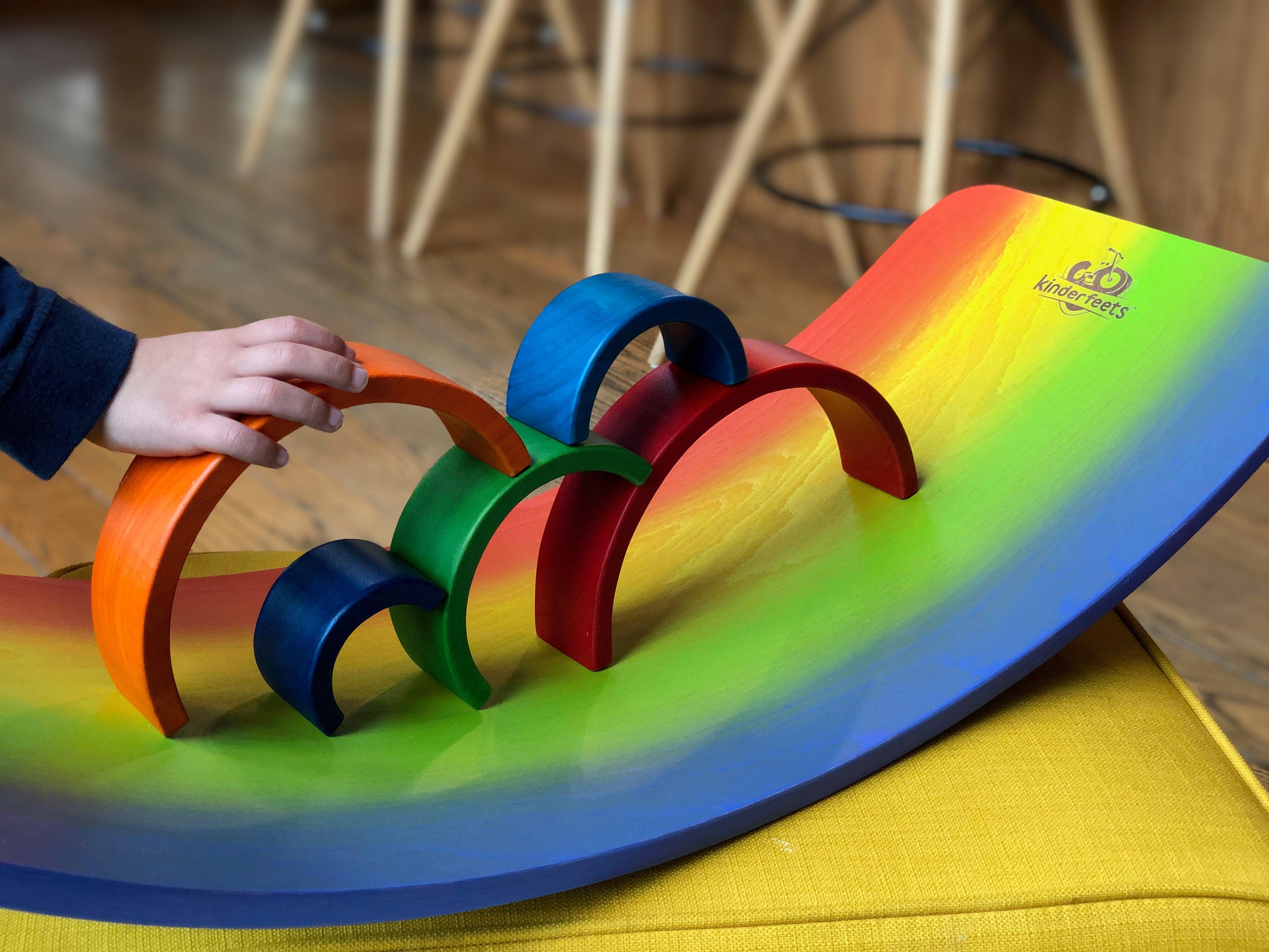 Kinderfeets Rainbow Kinderboard balance board with colorful rainbow design and wooden construction for kids' balance and coordination.
