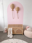 Large INKAH Rattan toy chest by Inkah Limited with woven rattan design and sturdy wooden legs.