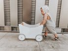 Kinderfeets wooden toy box and walker in white and bamboo, featuring a sturdy design and smooth finish for children.