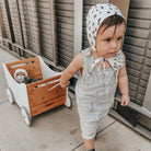Kinderfeets wooden toy box and walker in white and bamboo, featuring a sturdy design with a built-in storage compartment.