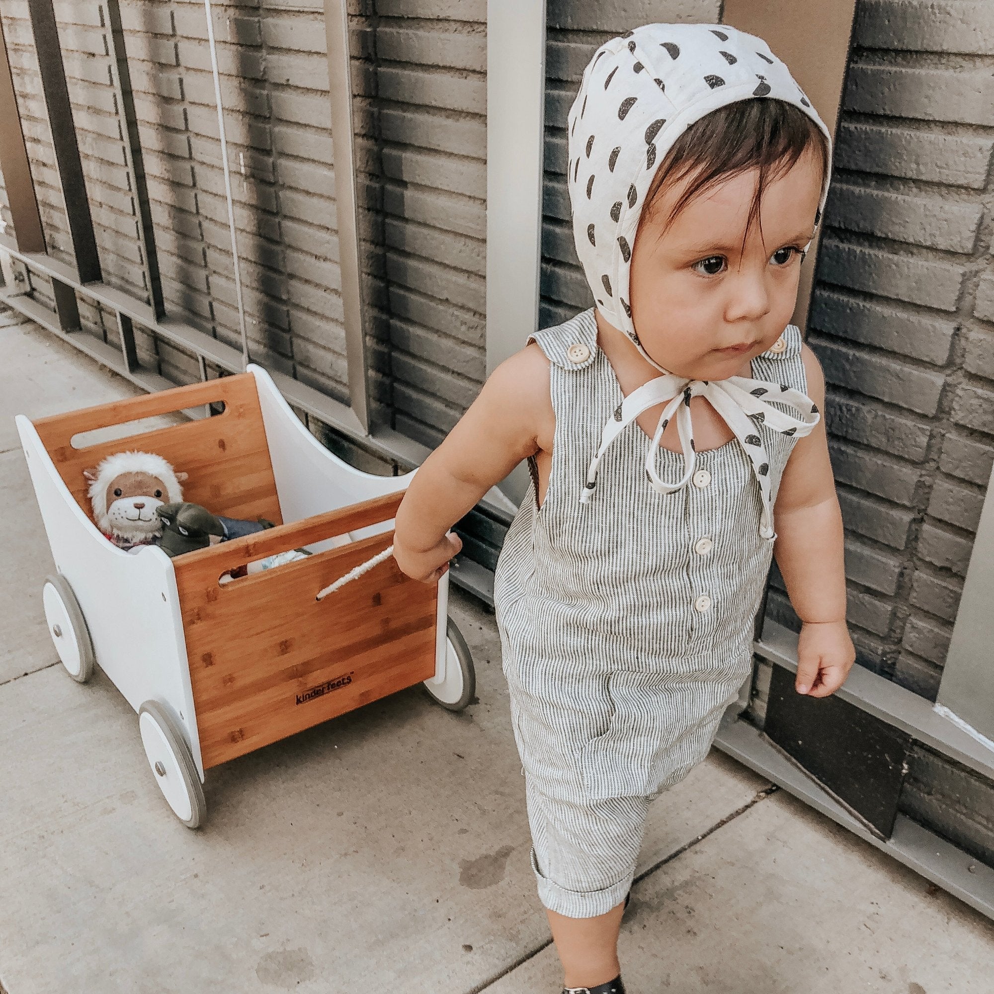 Kinderfeets wooden toy box and walker in white and bamboo, featuring a sturdy design with a built-in storage compartment.