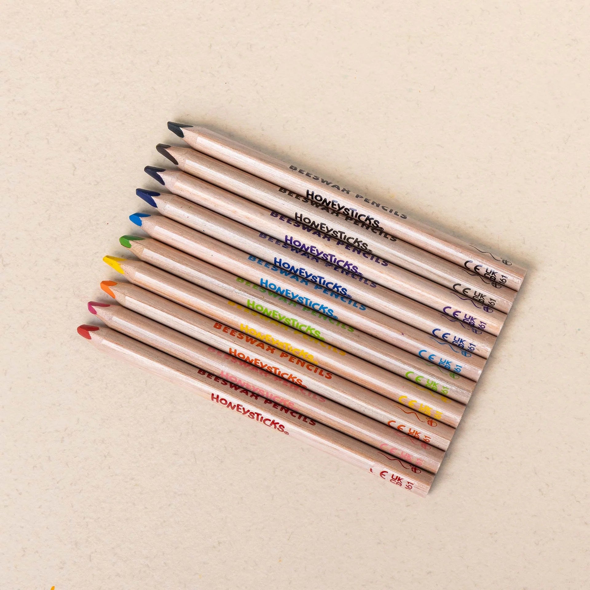 Set of ten Honeysticks Magic 3-in-1 beeswax crayon pencils in jumbo triangle shape, colorful and kid-friendly.